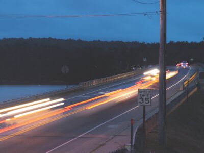 timelapse photography of vehicle passing on road