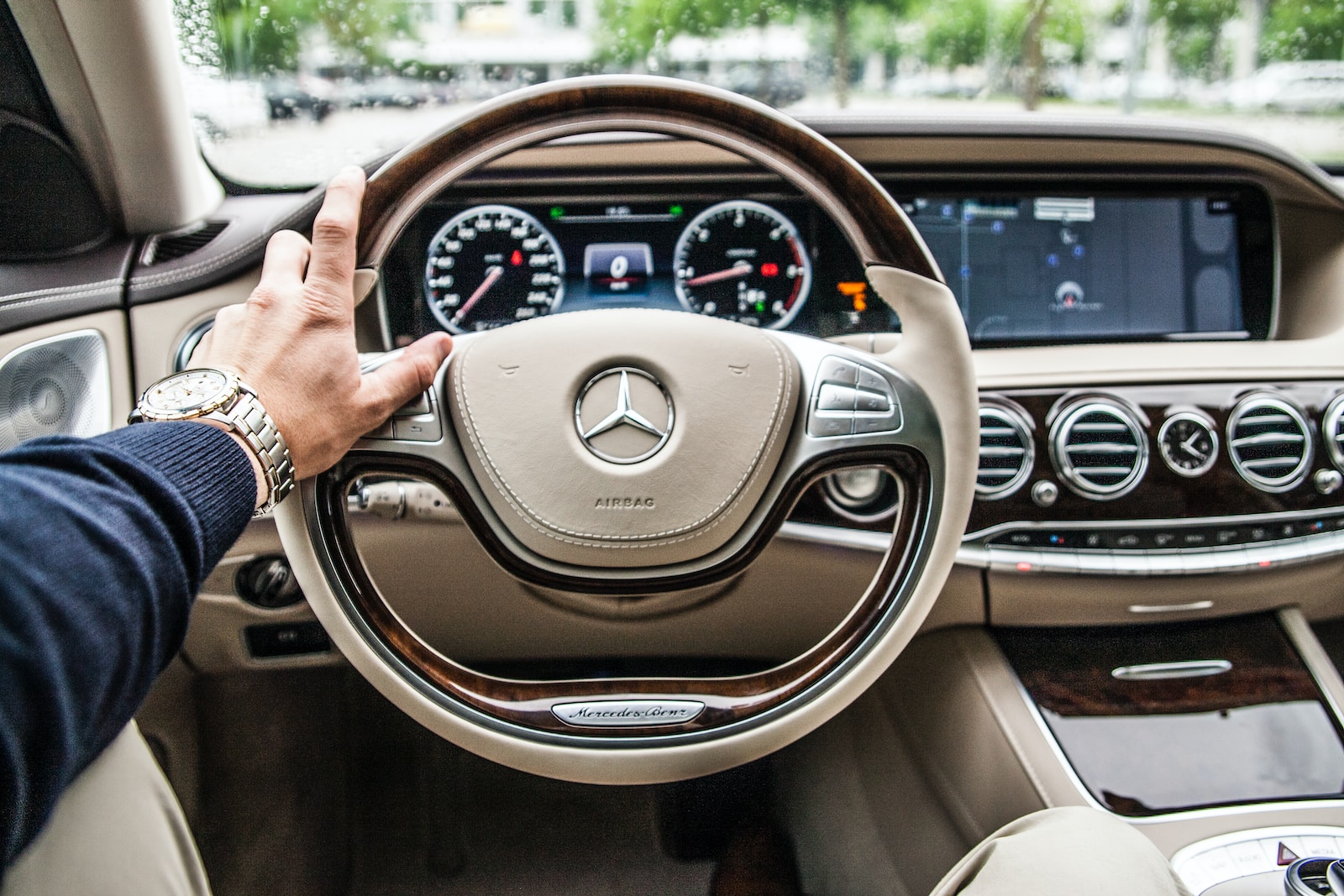 person sitting in Mercedes-Benz driver's seat