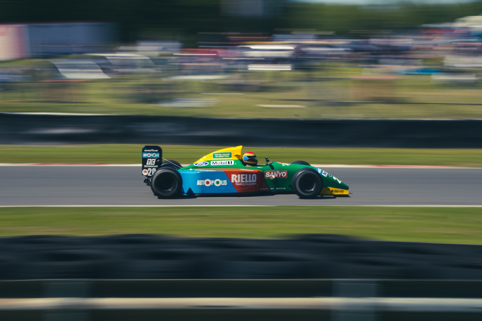 blue and yellow f1 car on road