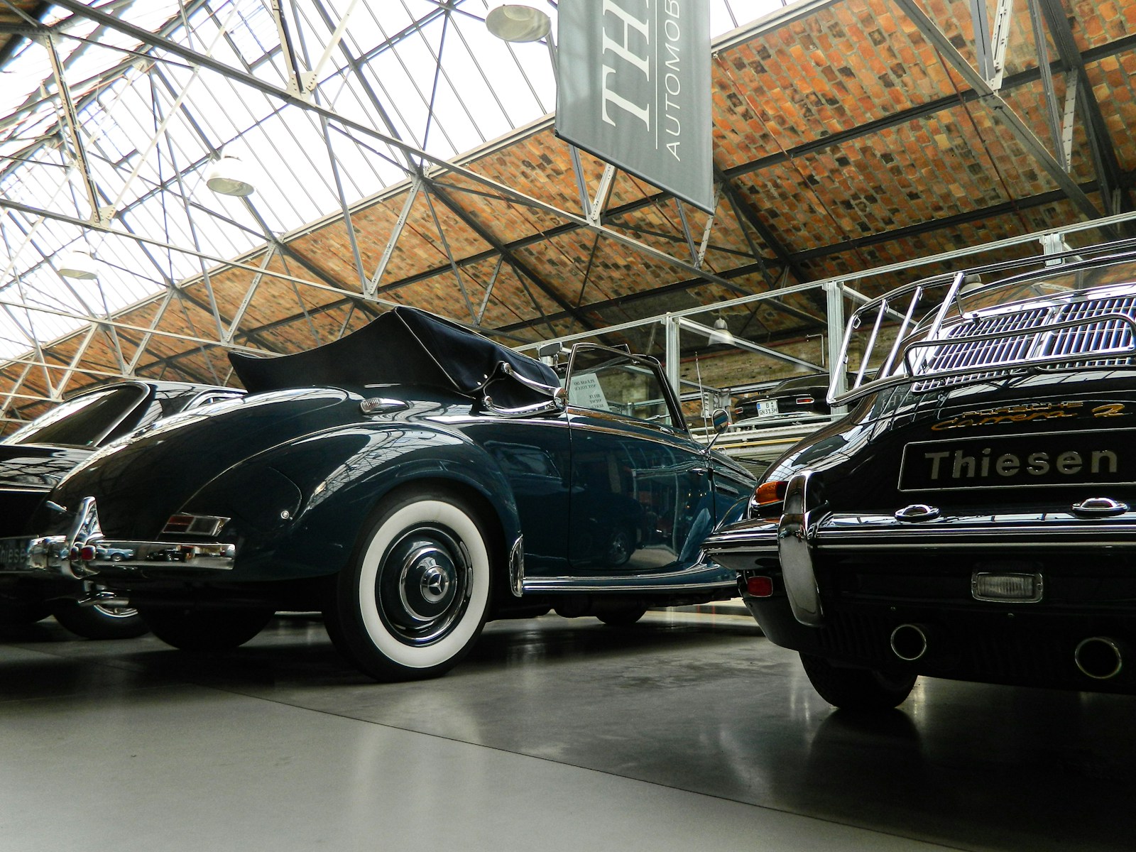 a couple of cars parked inside of a building